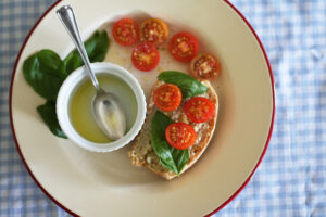home baked spelt bread with cherry tomatoes, basil and extra virgin olive oil